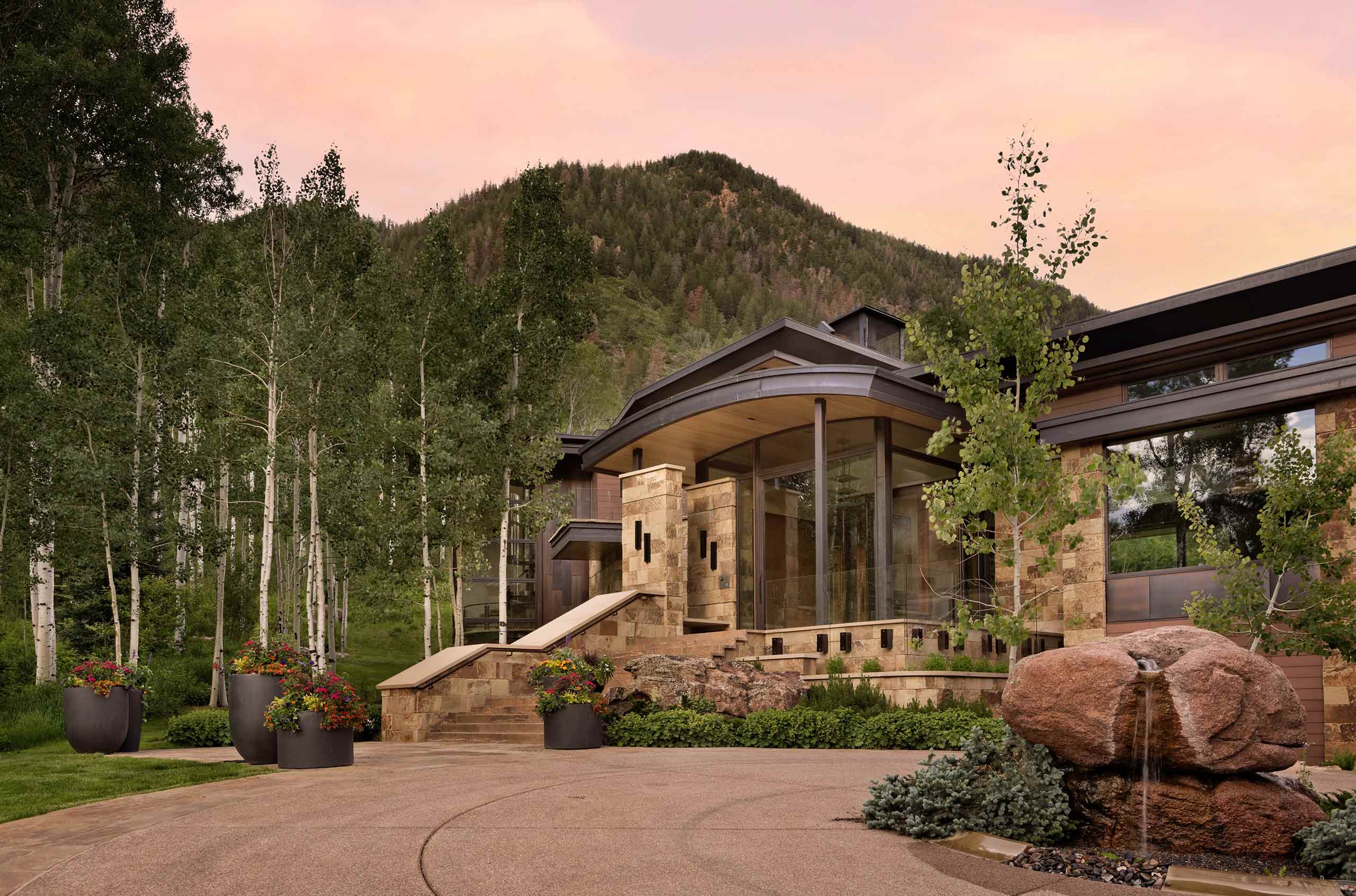 Driveway of an Aspen Cuvée luxury villa with sweeping mountain views, oversized glass windows, and remote mountain location.