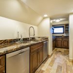 Luxury kitchen in a villa with wood cabinets, granite countertops, and modern appliances.