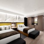 Modern luxury bedroom with two double beds, fur accents, wood flooring, and abstract wall art, in a high-end rental in Aspen, Colorado.