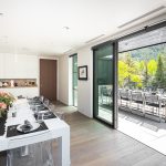 Elegant dining room and outdoor terrace with mountain views at a luxury villa in Aspen, Colorado.