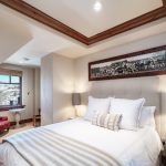 Bedroom in a luxury villa with a comfortable bed, elegant decor, and a window with a view, located in Beaver Creek, Colorado.
