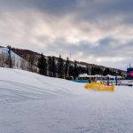 Snowy mountain landscape with ski lifts and buildings in Vail, Colorado.