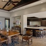 Luxury villa dining and kitchen area with wood furniture and tropical decor.