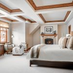 Ritz Carlton Bachelor Gulch WHRRZ Luxury bedroom in a villa with a fireplace, elegant decor, and large windows offering an outside view.