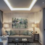 Luxurious living room with modern decor, featuring a plush sofa with green and patterned cushions, abstract artwork on the wall, two side tables with contemporary lamps, and a view of greenery through a large window.