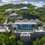 Aerial view of a luxury villa with a pool in a lush, tropical setting in St. Barts, Caribbean.