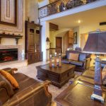 Luxurious living room with leather sofas and a fireplace in a high-end villa.