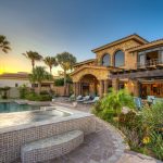 Luxury villa with swimming pool and garden, Los Cabos, Mexico, at sunset.